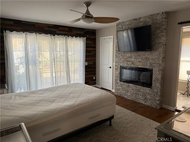 a bedroom with a bed and a fireplace
