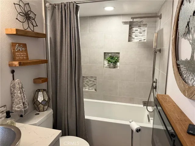 a bathroom with a sink a toilet and bathtub