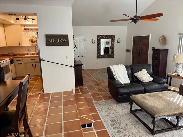 a living room with furniture a rug and a table