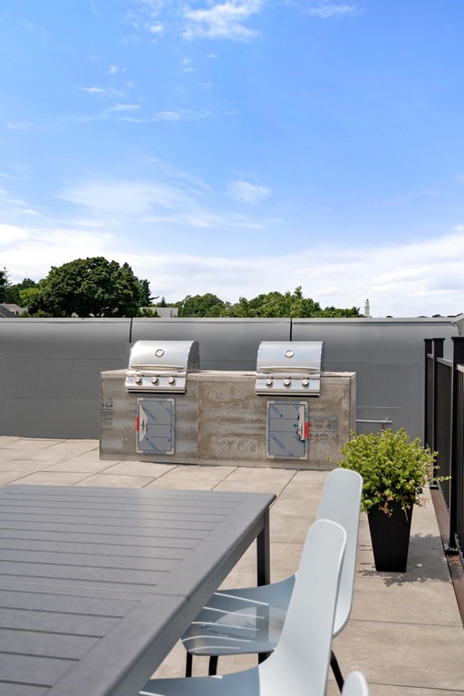 69 Walnut Street, Unit 15 Brookline, MA 02445 - Photo 18 of 21 a view of a terrace with furniture