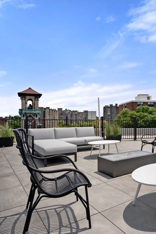 69 Walnut Street, Unit 15 Brookline, MA 02445 - Photo 19 of 21 a terrace with outdoor seating and city view