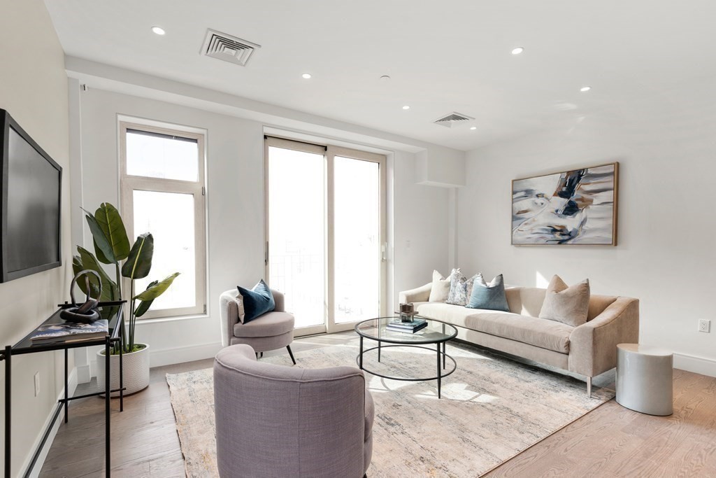 69 Walnut Street, Unit 15 Brookline, MA 02445 - Photo 7 of 21 a living room with furniture and a large window