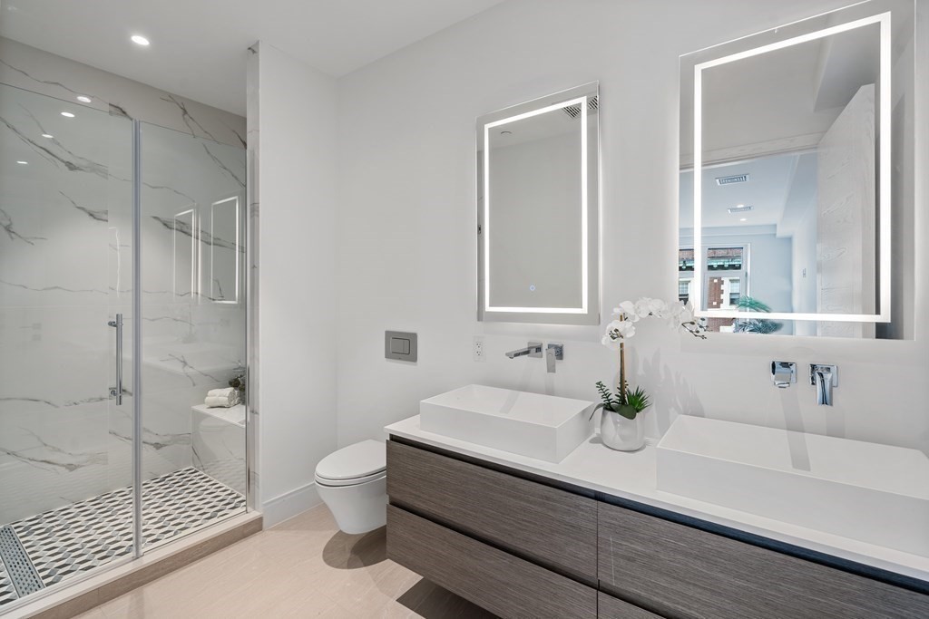 69 Walnut Street, Unit 15 Brookline, MA 02445 - Photo 9 of 21 a bathroom with a sink a toilet and shower