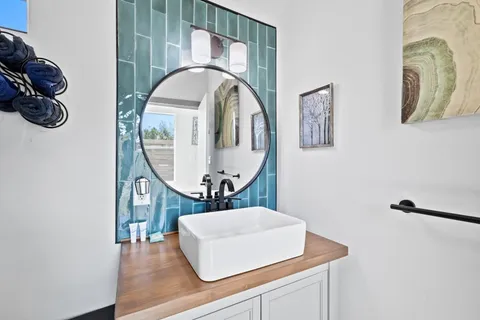 a bathroom with a toilet a sink and mirror