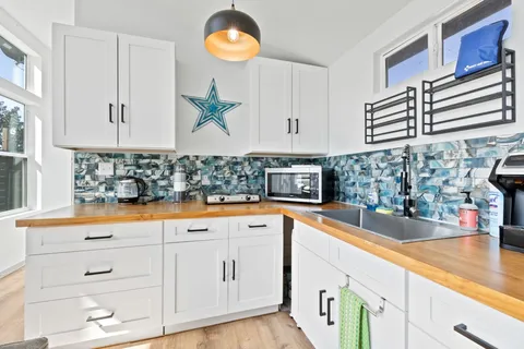 a kitchen with stainless steel appliances granite countertop a sink and a stove