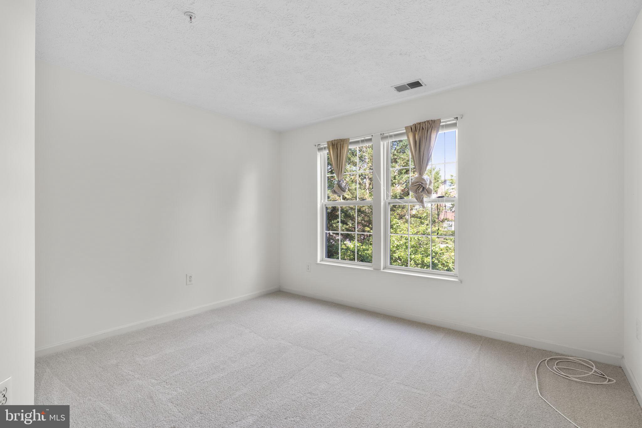2444 Blue Spring Court, Unit 203 Odenton, MD 21113 - Photo 24 of 36 an empty room with windows