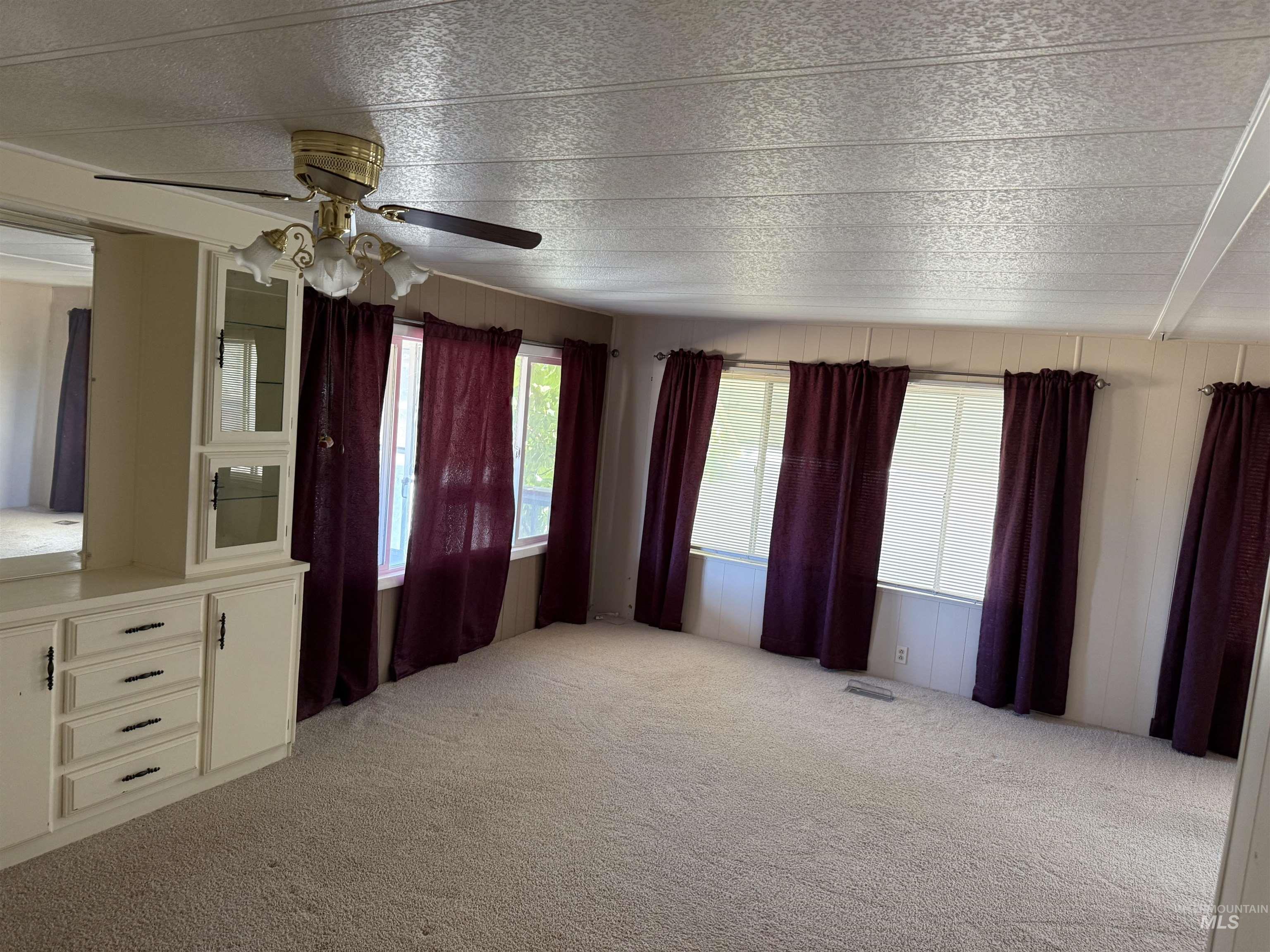 6 Blue Spruce Drive Hagerman, ID 83332 - Photo 8 of 16 Unfurnished living room featuring light carpet and a ceiling fan