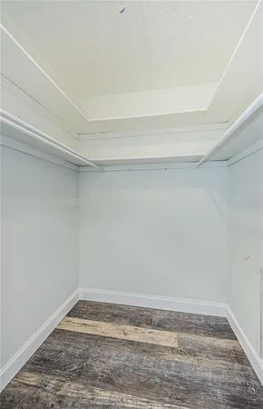 a bathroom with a granite countertop toilet sink and mirror