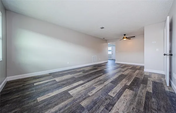 a view of a room with wooden floor