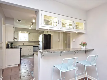 a kitchen with a sink cabinets and window