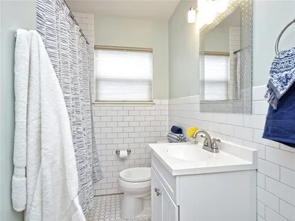 a bathroom with a sink a toilet and a mirror