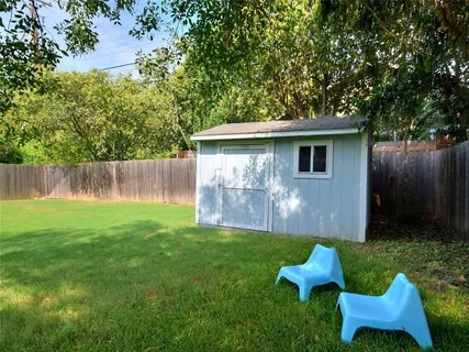 a view of a chair and table in the back yard