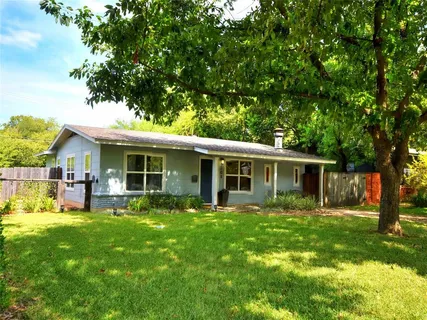 a view of a house with a yard and sitting area
