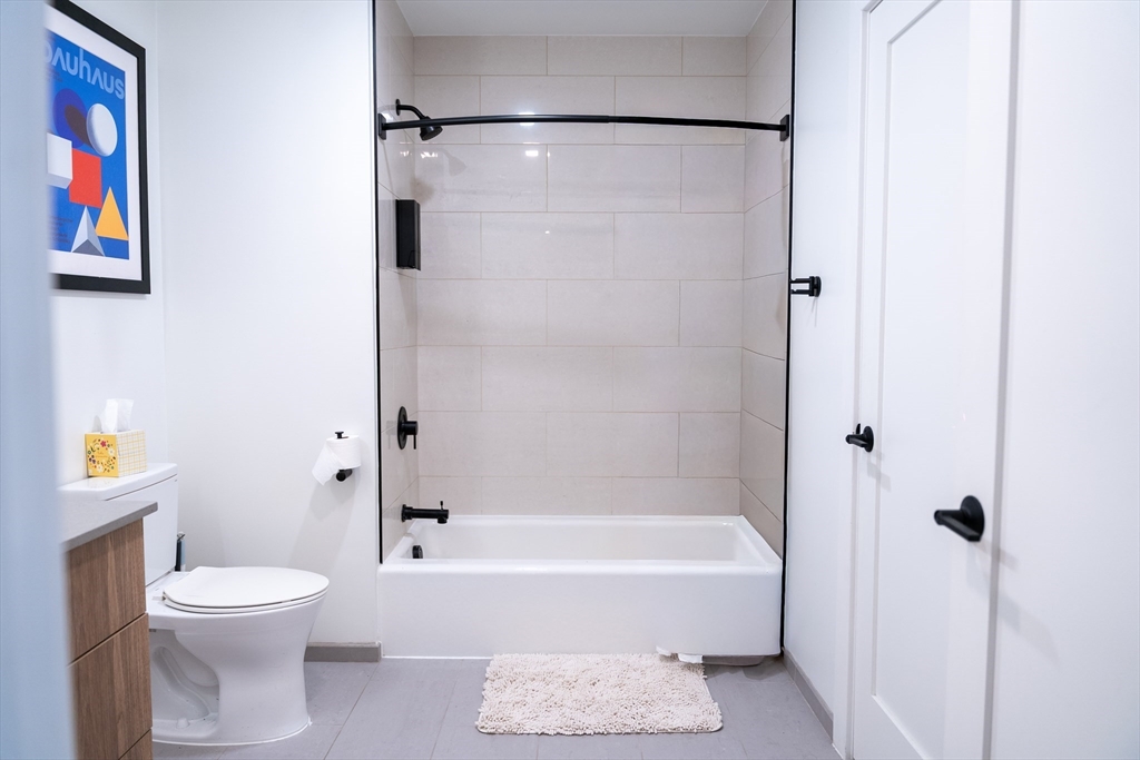 2 Sinclair Road, Unit 202 Boston, MA 02134 - Photo 14 of 23 a bathroom with a toilet and a bathtub