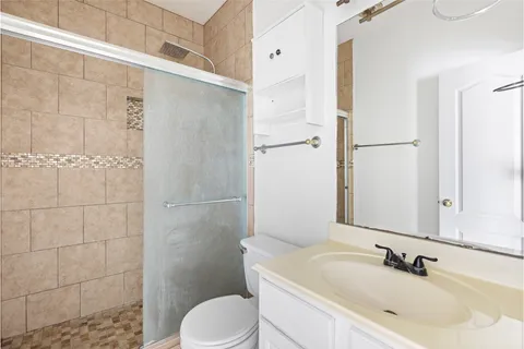 a bathroom with a sink toilet and shower