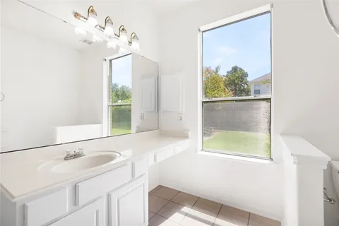 a bathroom with a sink a bathtub and a window