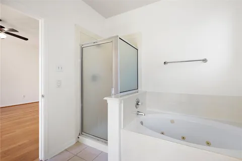 a bathroom with a bathtub and a shower