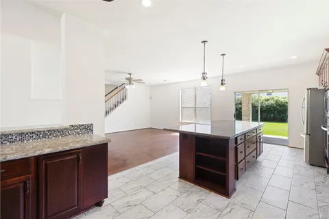 a open kitchen with granite countertop a sink and a stove