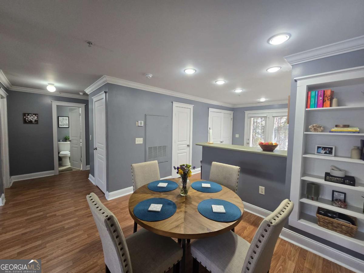 490 Barnett Shoals Road, Unit 205 Athens, GA 30605 - Photo 12 of 19 a view of a dining room with furniture and wooden floor