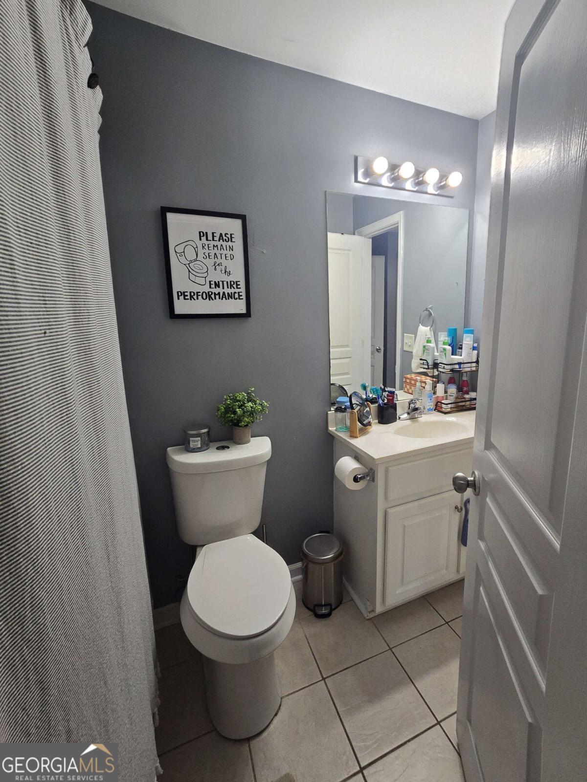 490 Barnett Shoals Road, Unit 205 Athens, GA 30605 - Photo 16 of 19 a bathroom with a toilet sink and mirror