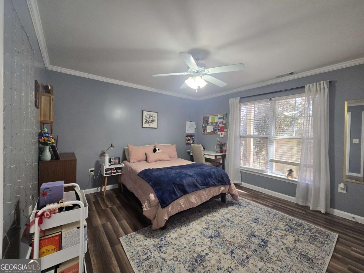 490 Barnett Shoals Road, Unit 205 Athens, GA 30605 - Photo 17 of 19 a living room with a bed furniture and next to a window