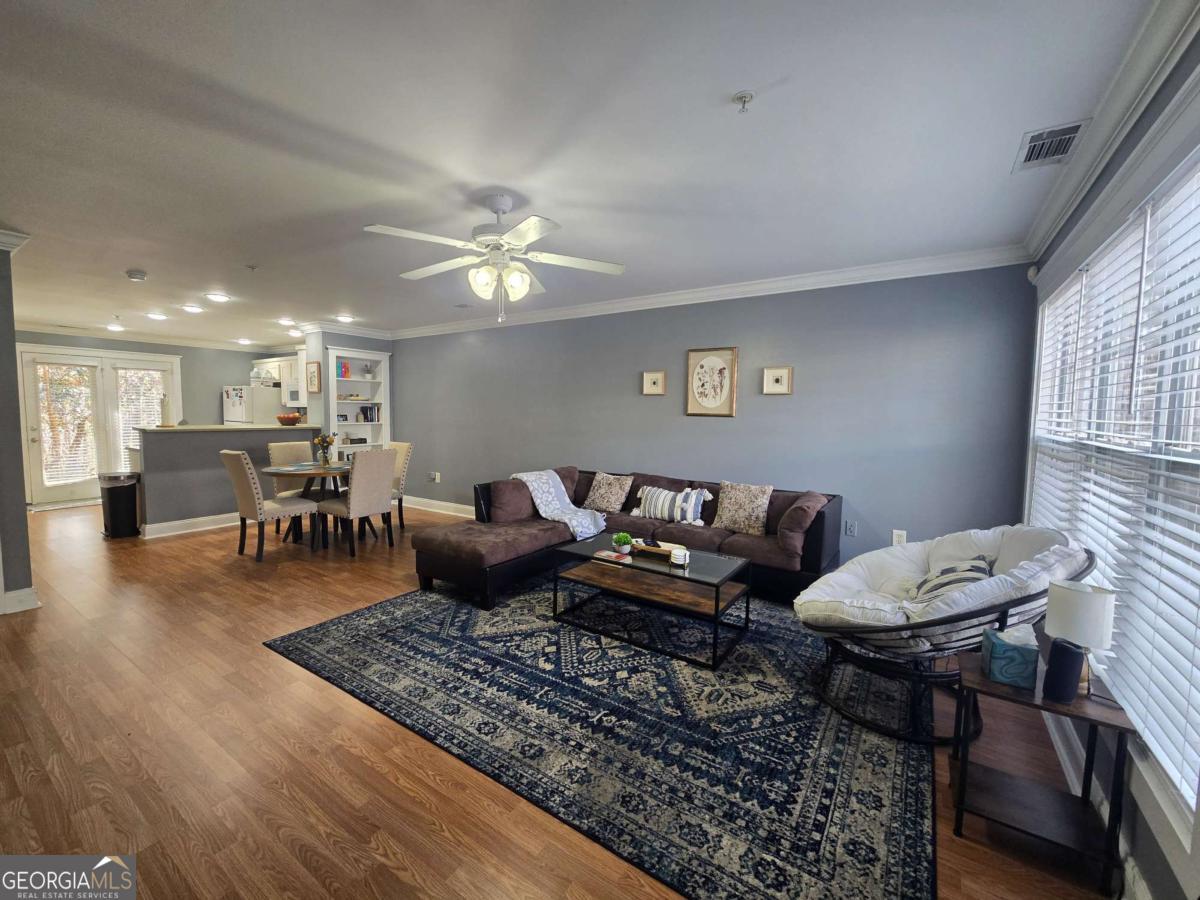 490 Barnett Shoals Road, Unit 205 Athens, GA 30605 - Photo 4 of 19 a living room with furniture and wooden floor