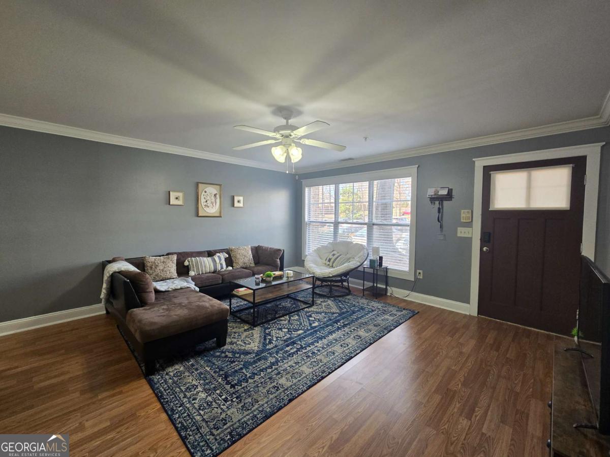 490 Barnett Shoals Road, Unit 205 Athens, GA 30605 - Photo 5 of 19 a living room with furniture and wooden floor