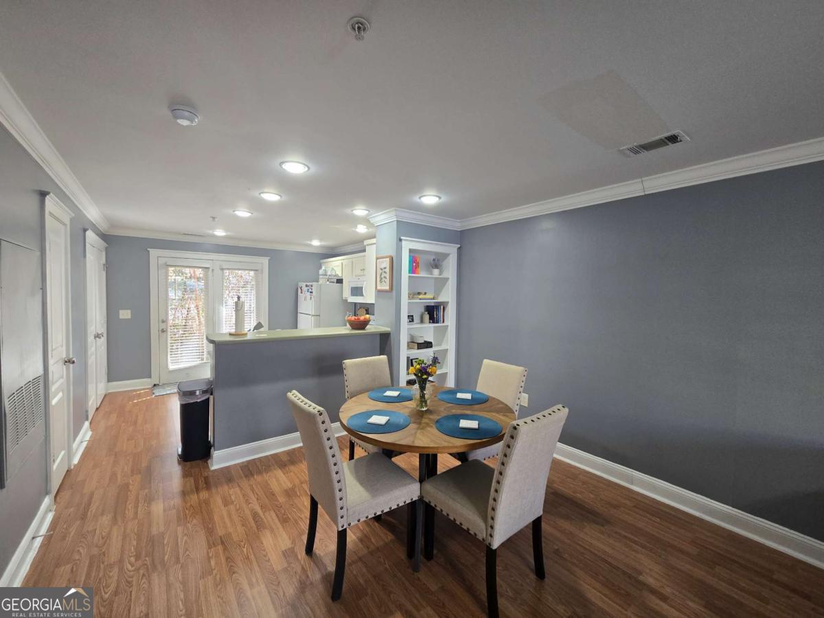 490 Barnett Shoals Road, Unit 205 Athens, GA 30605 - Photo 6 of 19 a view of a dining room with furniture and wooden floor