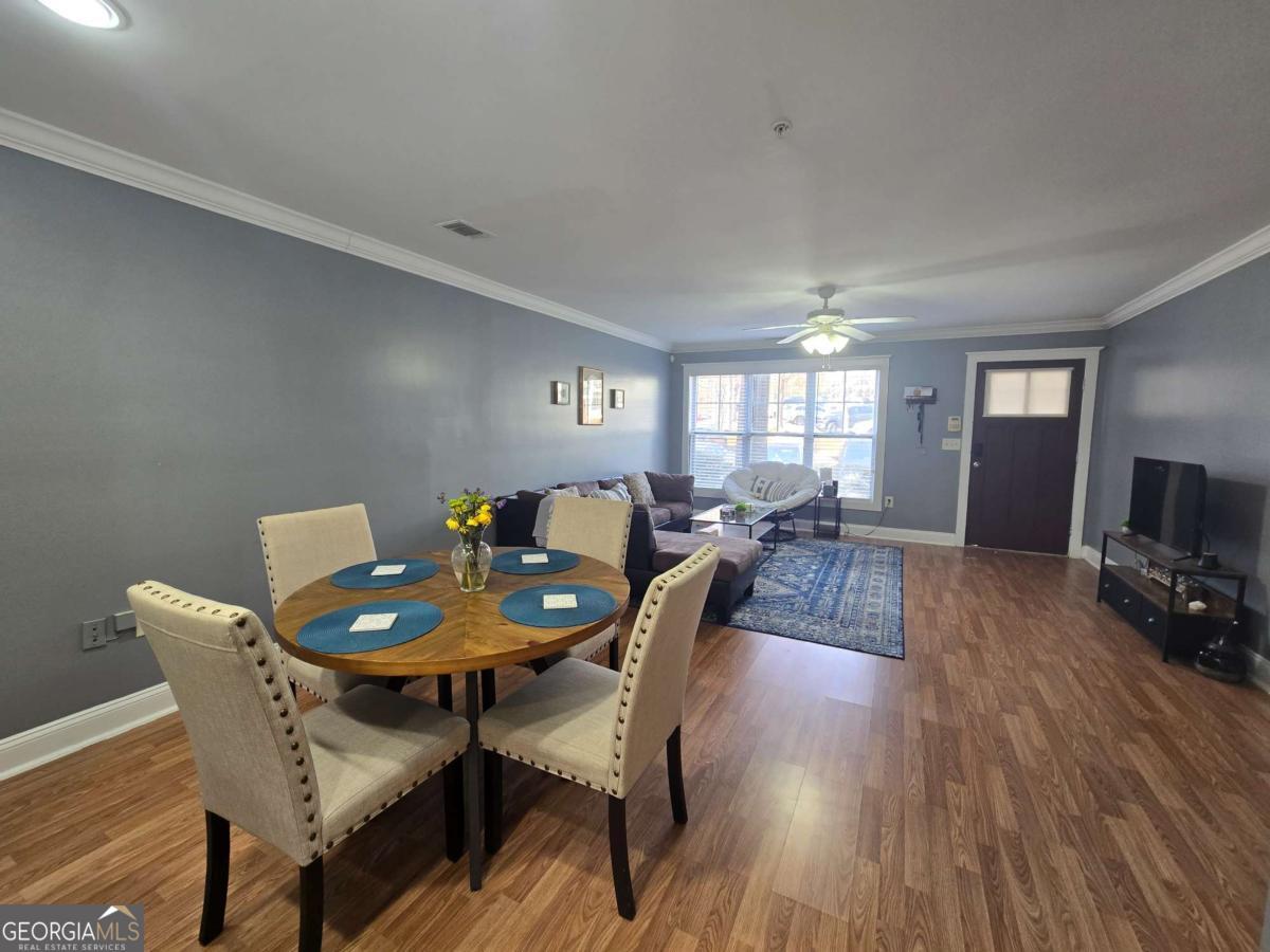 490 Barnett Shoals Road, Unit 205 Athens, GA 30605 - Photo 7 of 19 a view of a dining room with furniture and wooden floor