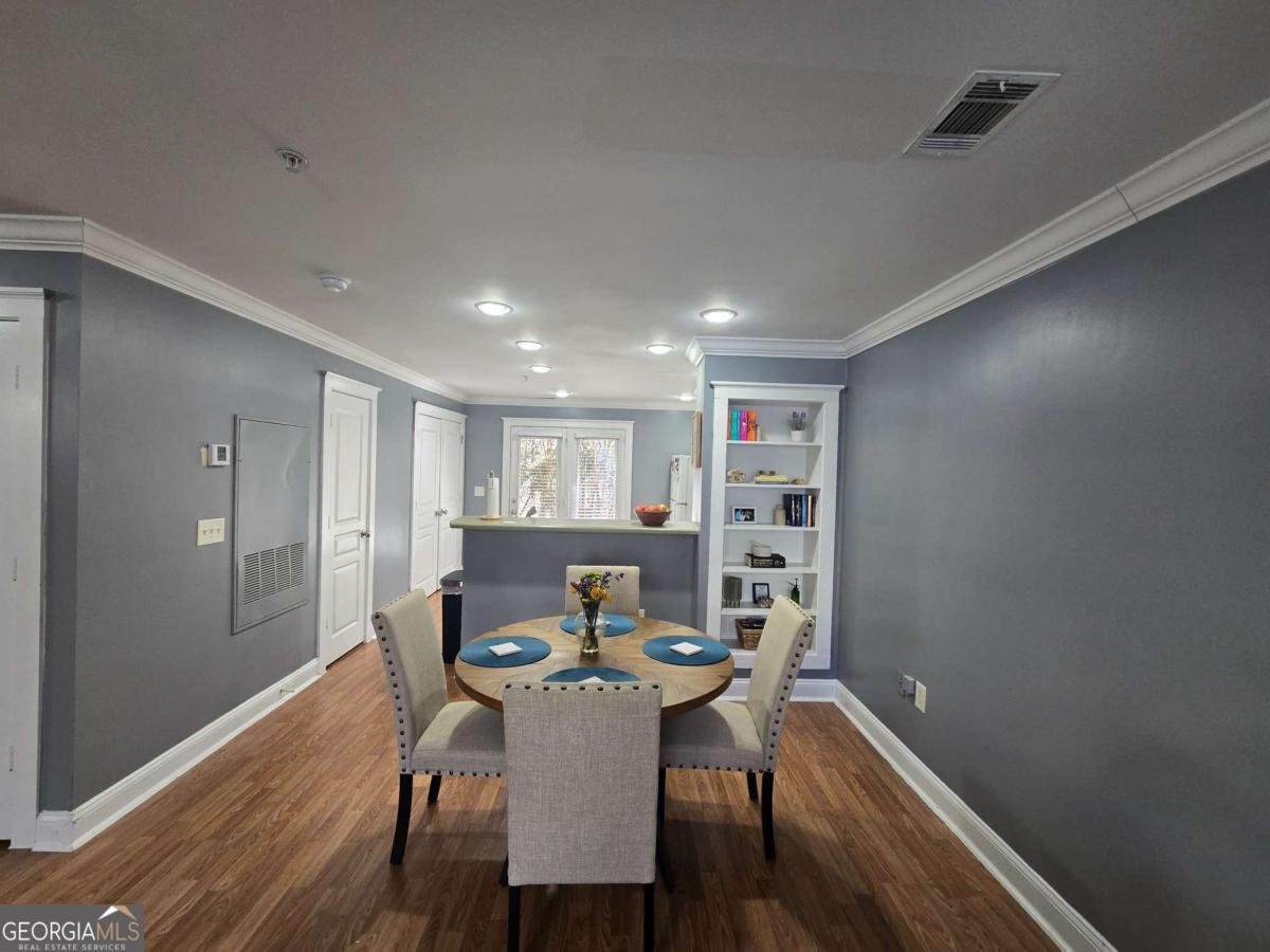 490 Barnett Shoals Road, Unit 205 Athens, GA 30605 - Photo 8 of 19 a view of a dining room with furniture and wooden floor