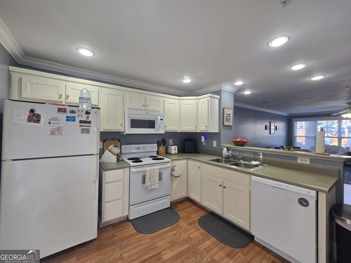 490 Barnett Shoals Road, Unit 205 Athens, GA 30605 - Photo 10 of 19 a kitchen with a sink a white cabinets and stainless steel appliances