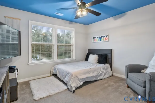 a bedroom with a bed couch and window
