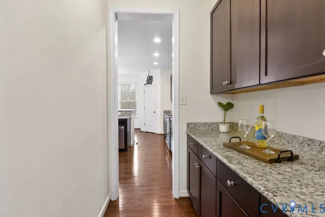 a kitchen with granite countertop a sink a stove and cabinets