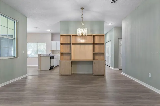 a kitchen with a sink a stove and cabinets