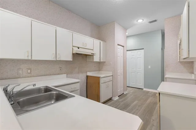 a utility room with cabinets washer and dryer