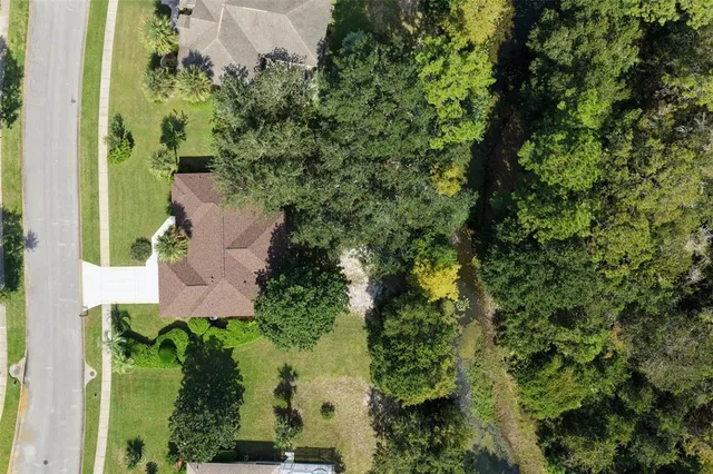 an aerial view of a house with a yard