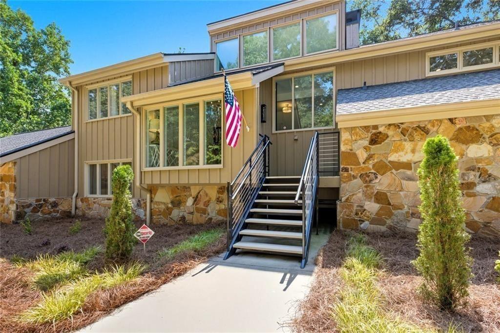 3680 Lamplighters Cove Road Gainesville, GA 30504 - Photo 11 of 88 a front view of a house with a garden
