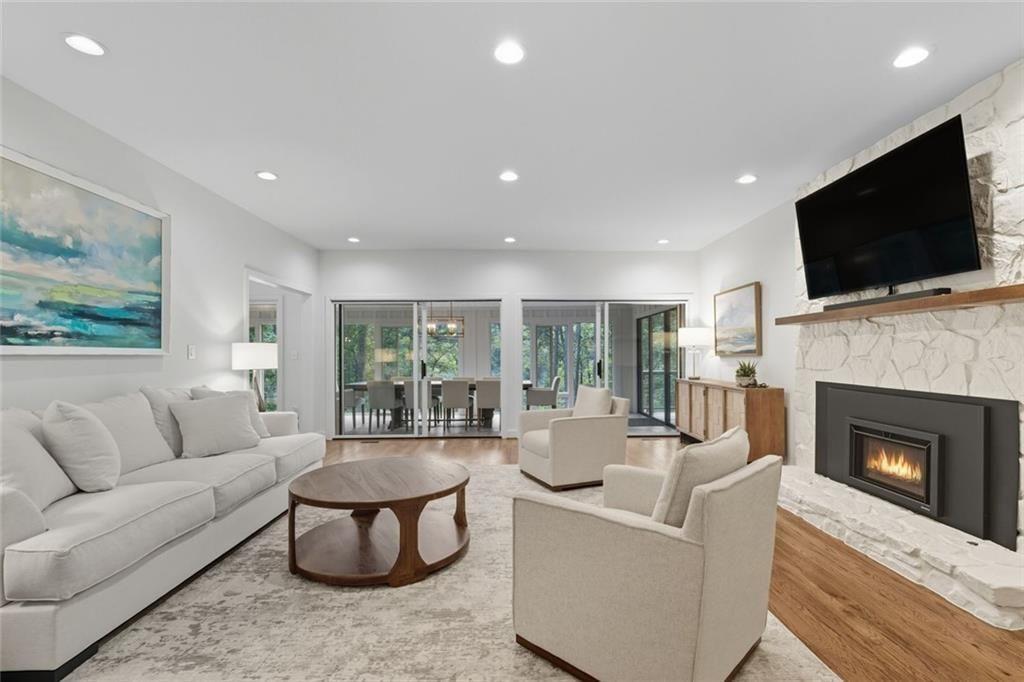 3680 Lamplighters Cove Road Gainesville, GA 30504 - Photo 13 of 88 a living room with fireplace furniture and a flat screen tv