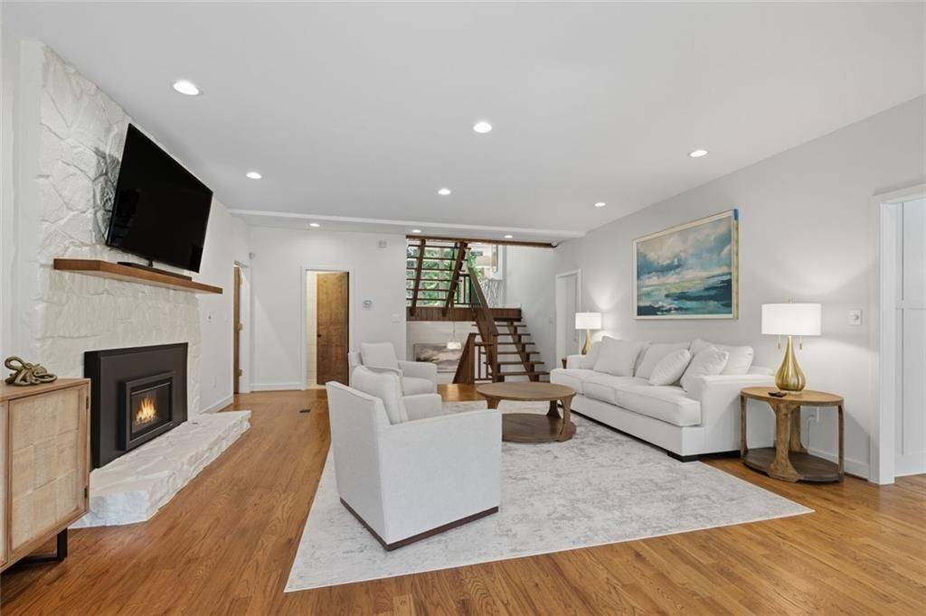 3680 Lamplighters Cove Road Gainesville, GA 30504 - Photo 15 of 88 a living room with furniture a fireplace and a flat screen tv