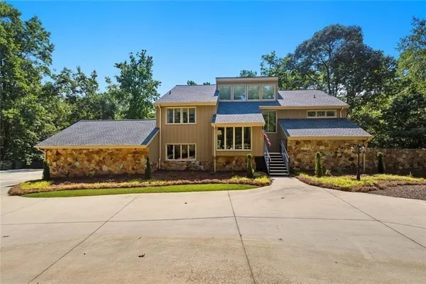 a front view of a house with garden