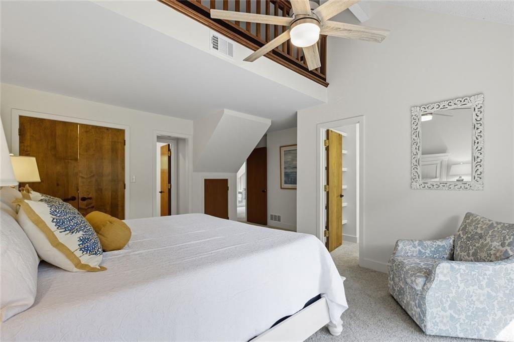 3680 Lamplighters Cove Road Gainesville, GA 30504 - Photo 38 of 88 a bedroom with a bed couch and mirror