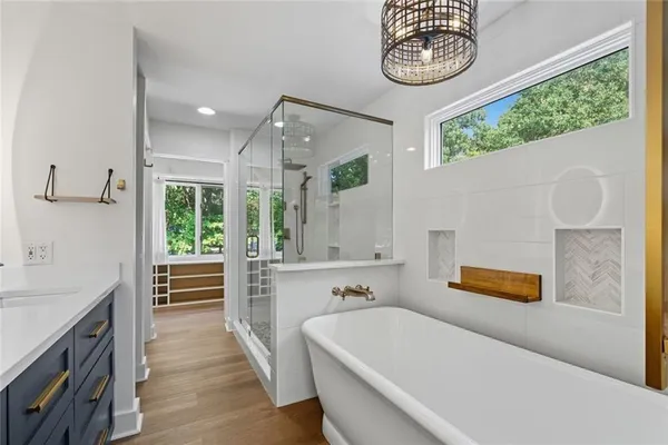 an aerial view of residential house with outdoor space and trees all around