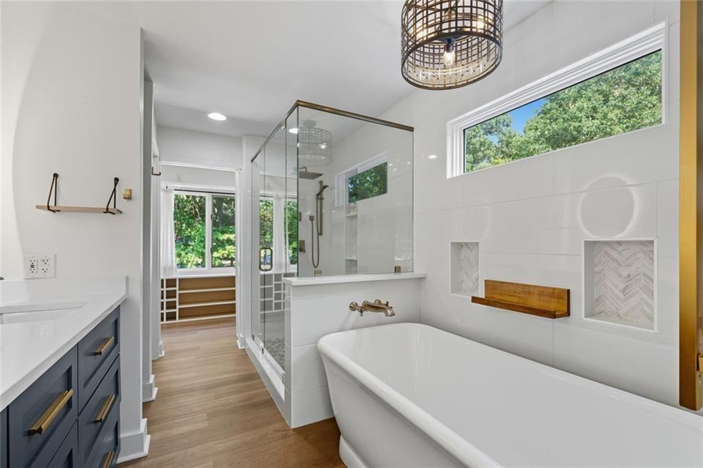 3680 Lamplighters Cove Road Gainesville, GA 30504 - Photo 45 of 88 a bathroom with a bathtub a sink and a window