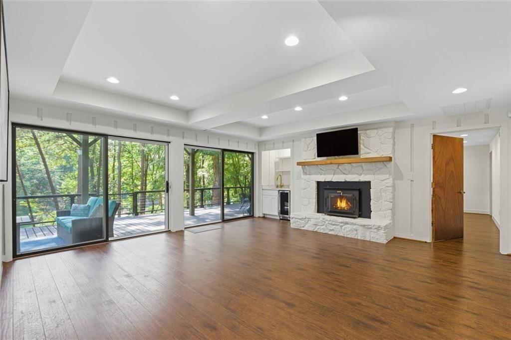 3680 Lamplighters Cove Road Gainesville, GA 30504 - Photo 55 of 88 a view of an empty room with wooden floor and a fireplace
