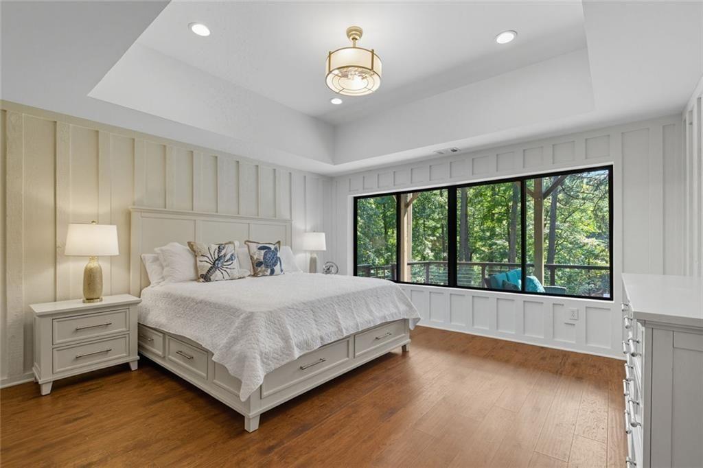 3680 Lamplighters Cove Road Gainesville, GA 30504 - Photo 56 of 88 a bedroom with a large bed and a large window