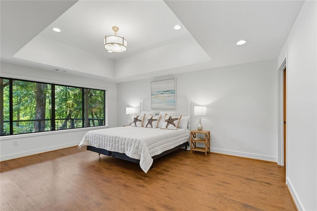 3680 Lamplighters Cove Road Gainesville, GA 30504 - Photo 61 of 88 a bedroom with a bed and a large window with outer view