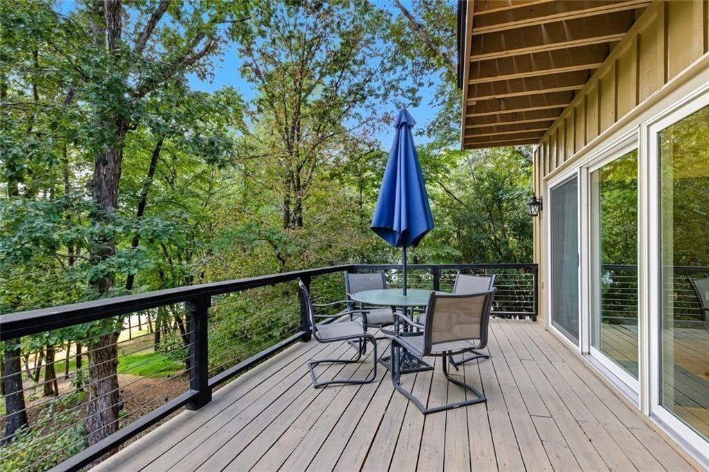 3680 Lamplighters Cove Road Gainesville, GA 30504 - Photo 71 of 88 a view of a chairs and table on the wooden deck