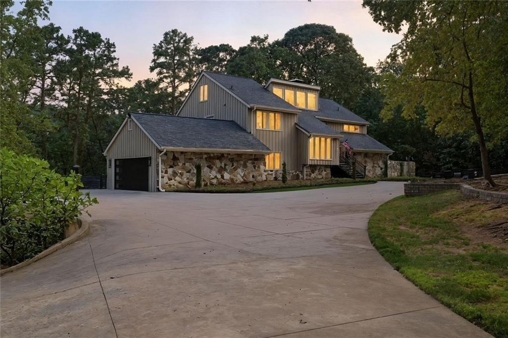 3680 Lamplighters Cove Road Gainesville, GA 30504 - Photo 9 of 88 a front view of a house with a yard and garage