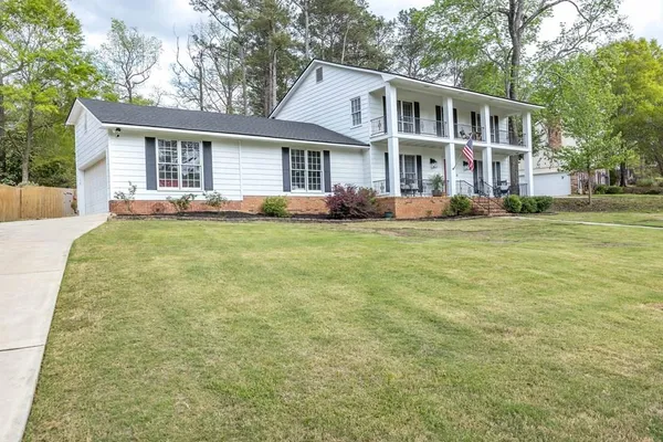 a front view of a house with a garden