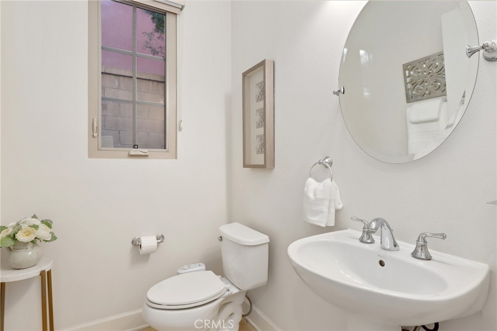 72 Brindisi Irvine, CA 92618 - Photo 20 of 48 a bathroom with a sink mirror and toilet